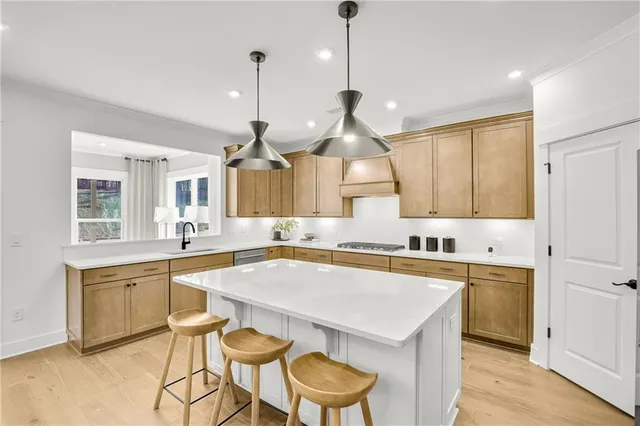 a kitchen with a stove a sink a table and chairs
