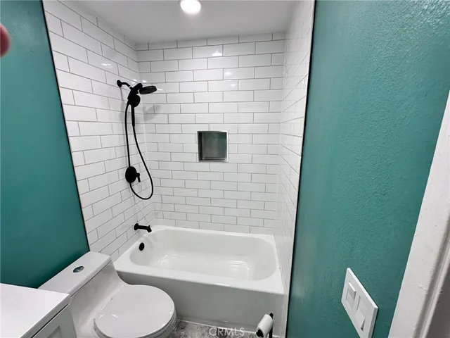 a bathroom with a shower toilet and sink