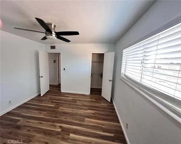 a view of a livingroom with a ceiling fan and window