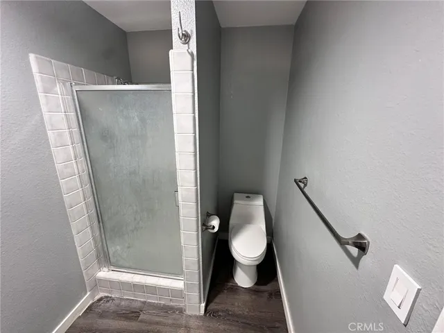 a bathroom with a toilet and a shower