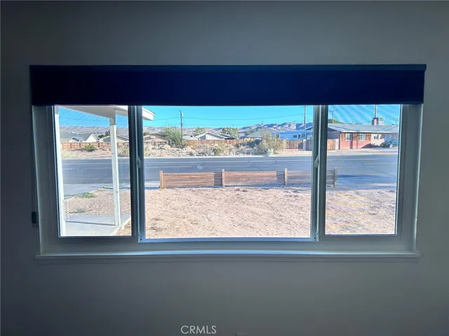 a view of a room that has a bed and a window