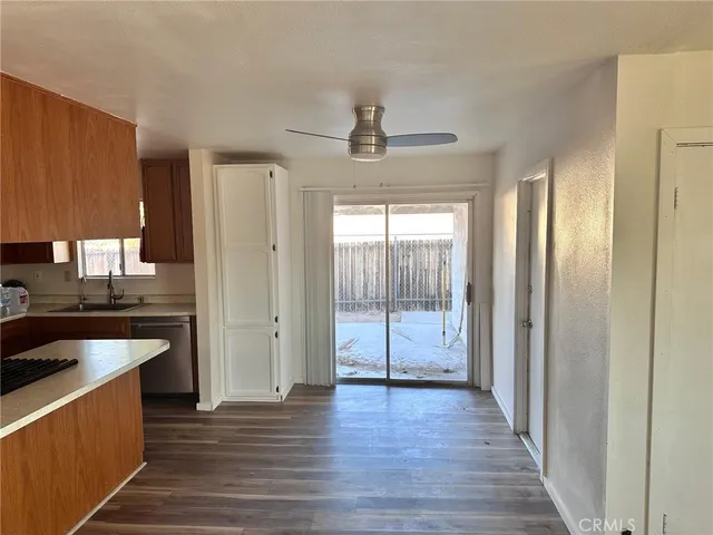 a view of a kitchen with a sink and a refrigerator