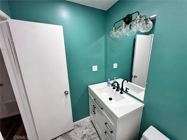 a bathroom with a sink vanity and mirror
