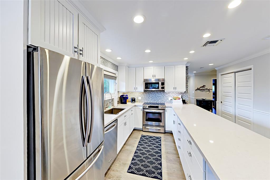 1758 Southeast 7th Street Fort Lauderdale, FL 33316 - Photo 14 of 19 a kitchen with stainless steel appliances a refrigerator sink and stove
