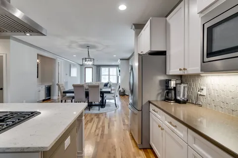 a kitchen with stainless steel appliances granite countertop a refrigerator stove microwave and sink