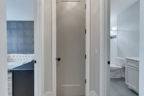 a bathroom with a granite countertop toilet and a shower