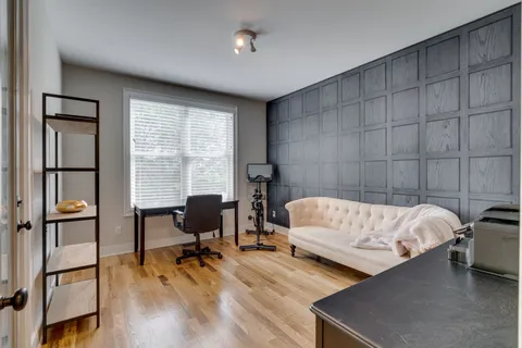 a bedroom with furniture and a window