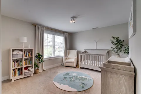 a bedroom with furniture and a book shelf