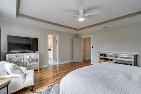 a bedroom with furniture and a flat screen tv