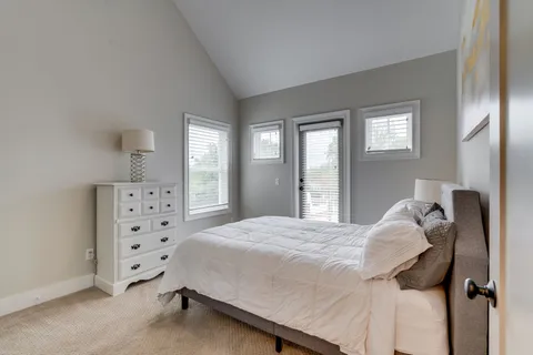 a bedroom with a bed and a with a large mirror