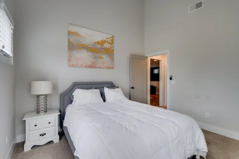 a bedroom with a bed and a night stand