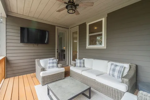 a outdoor living space with furniture and a ceiling fan