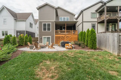 a view of a house with backyard sitting area and garden