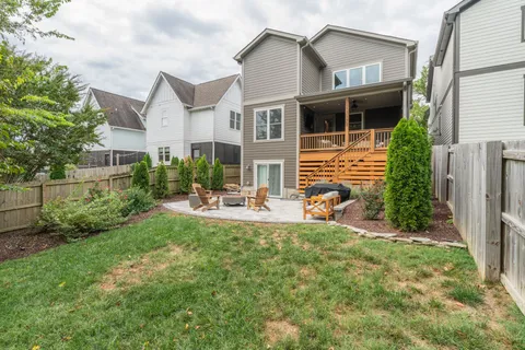 a view of a house with backyard porch and sitting area