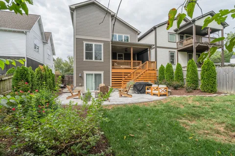 a view of a house with backyard sitting area and garden