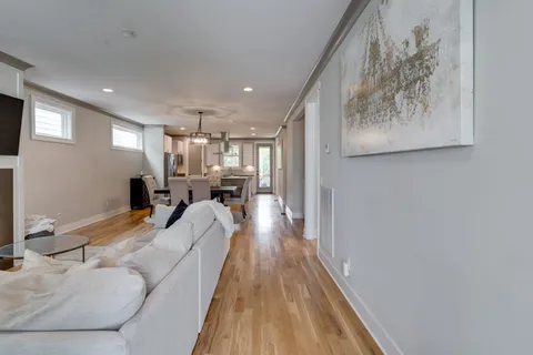 a living room with furniture and a chandelier