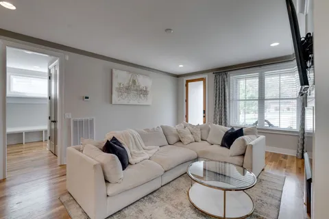 a living room with furniture and a large window