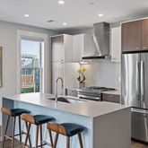 a kitchen with stainless steel appliances granite countertop a refrigerator and a sink