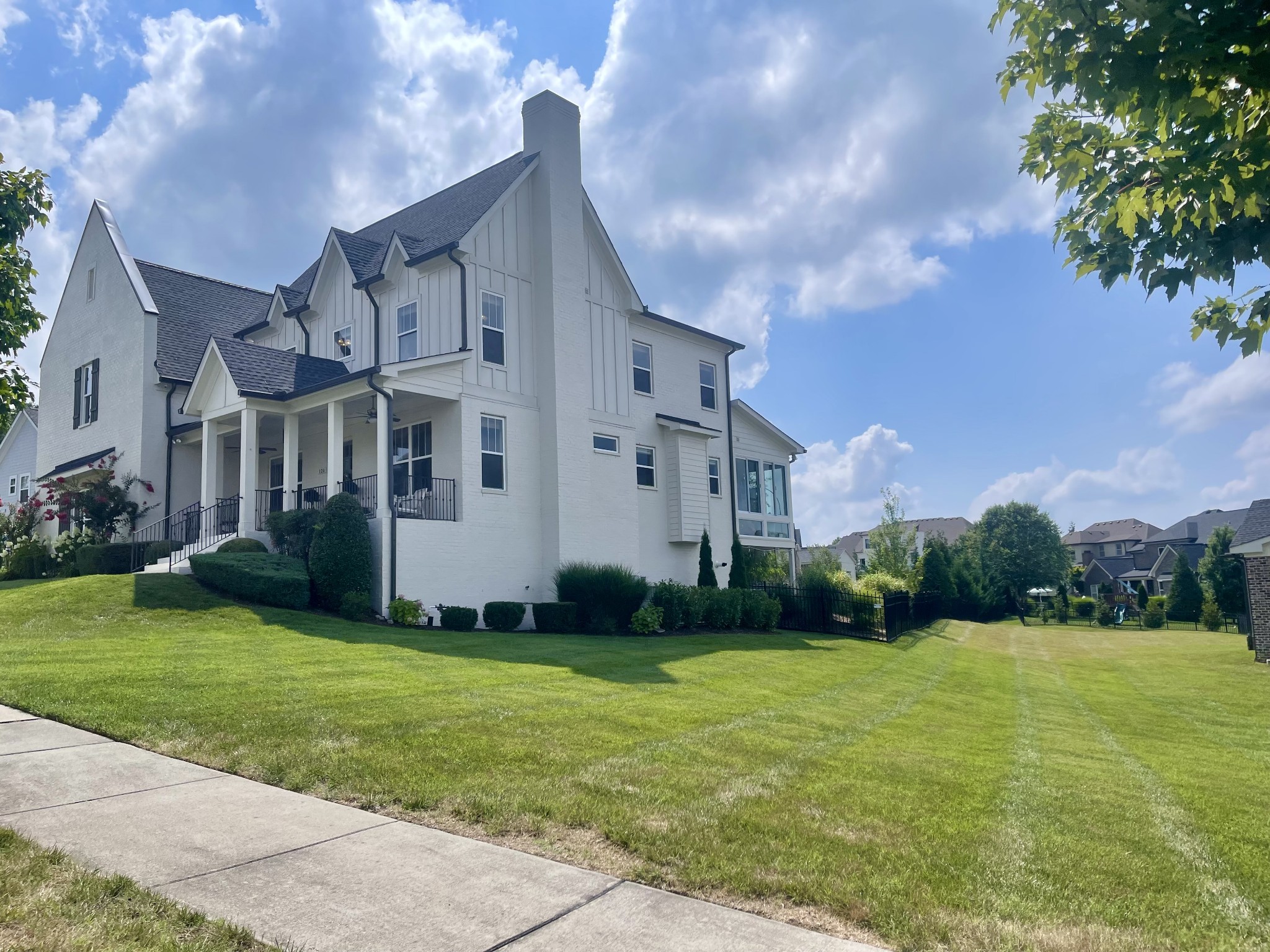 121 Princess Circle Franklin, TN 37064 - Photo 3 of 38 a view of a white house next to a yard with big trees