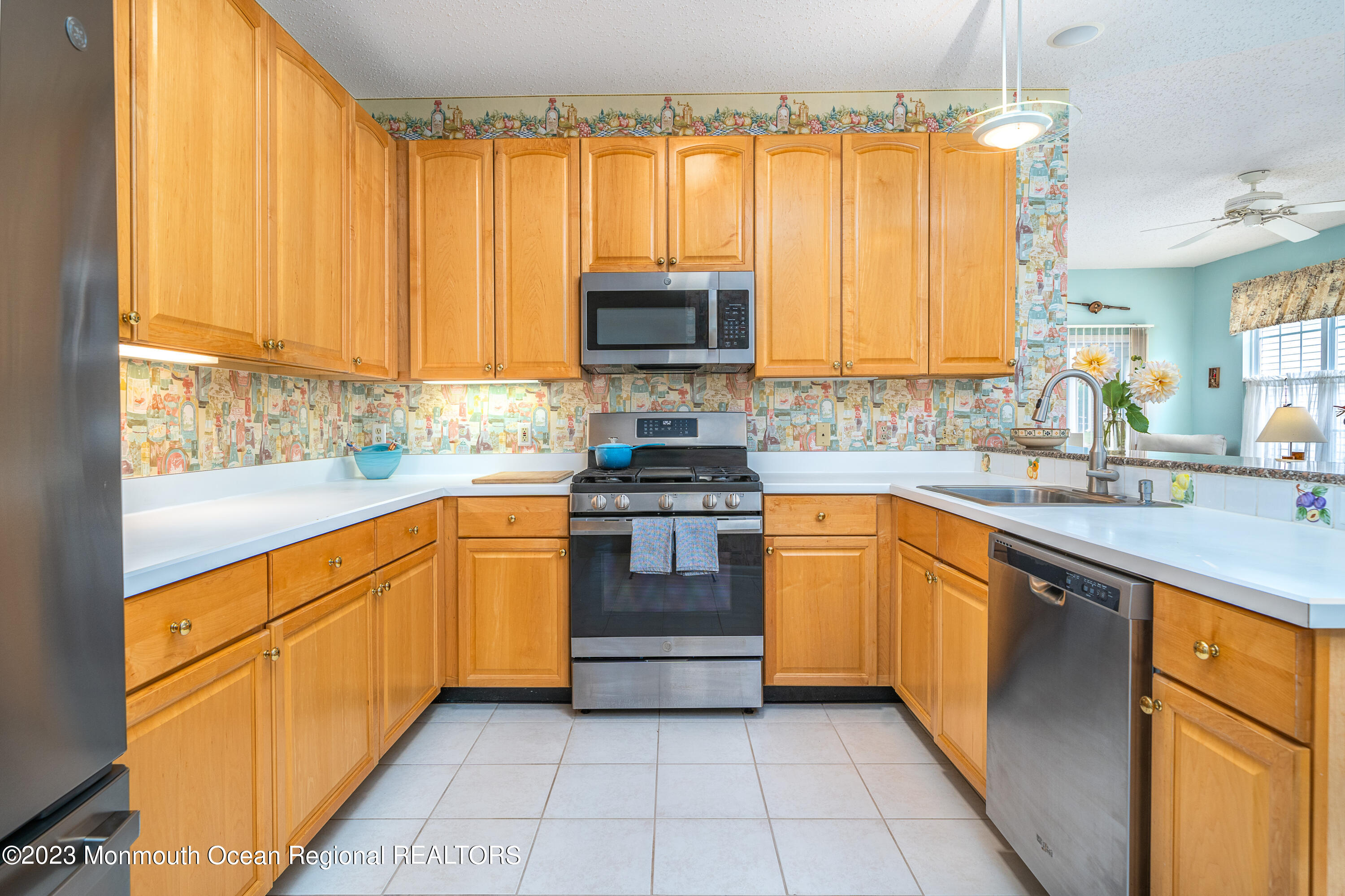44 Sandpiper Road Barnegat, NJ 08005 - Photo 9 of 27 a kitchen with stainless steel appliances granite countertop a stove a sink and a microwave