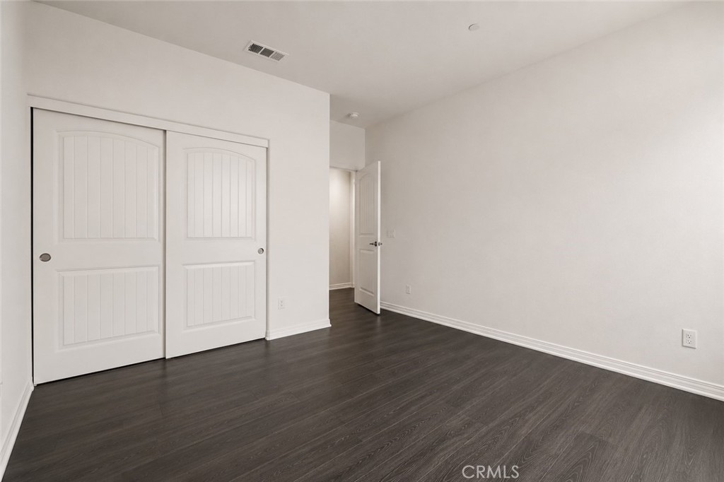 11056 Guffey Ranch Way Corona, CA 92883 - Photo 21 of 61 a view of an empty room with wooden floor