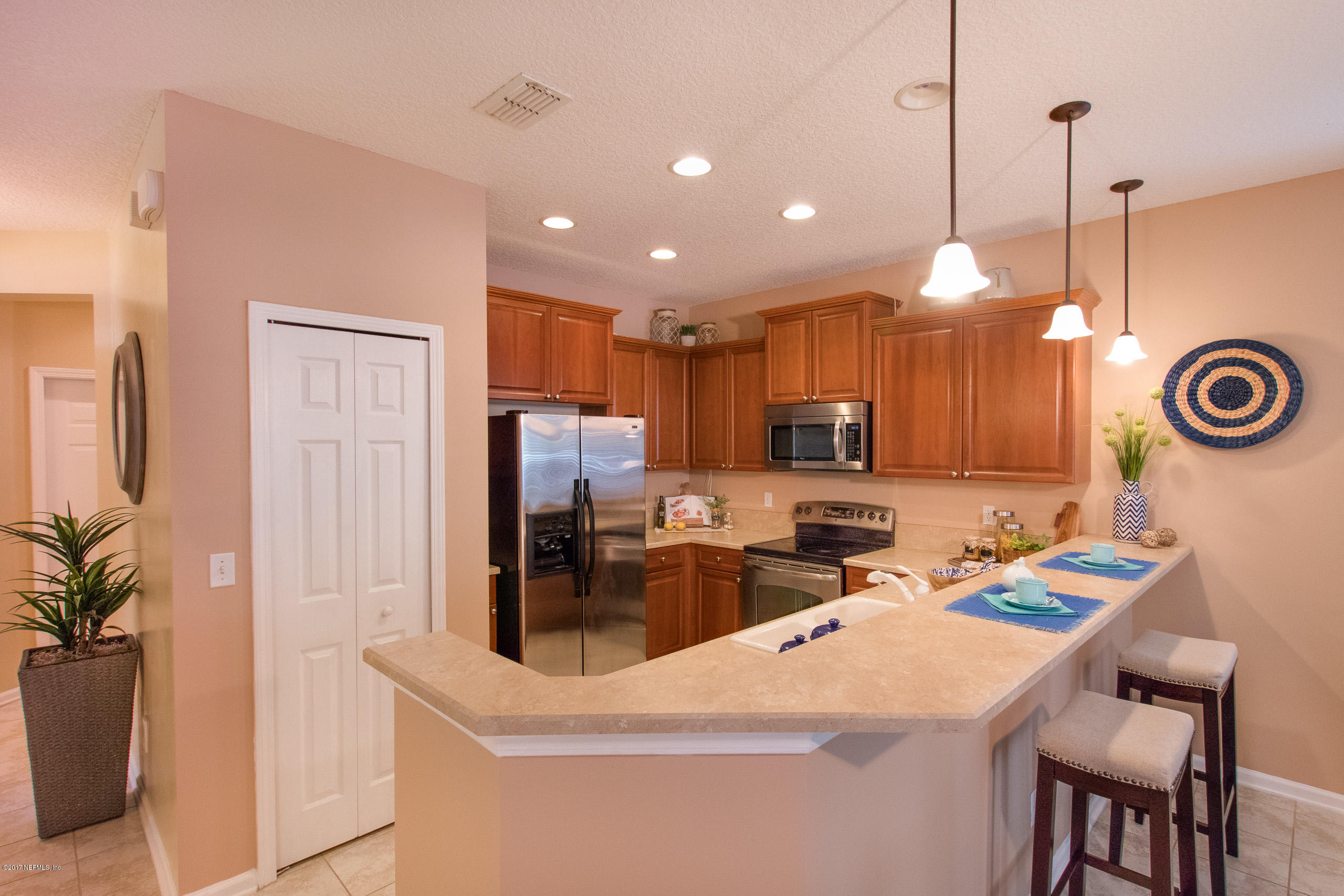 11855 Templeton Road Jacksonville, FL 32258 - Photo 11 of 23 a kitchen with stainless steel appliances kitchen island granite countertop a sink a stove and a wooden floors