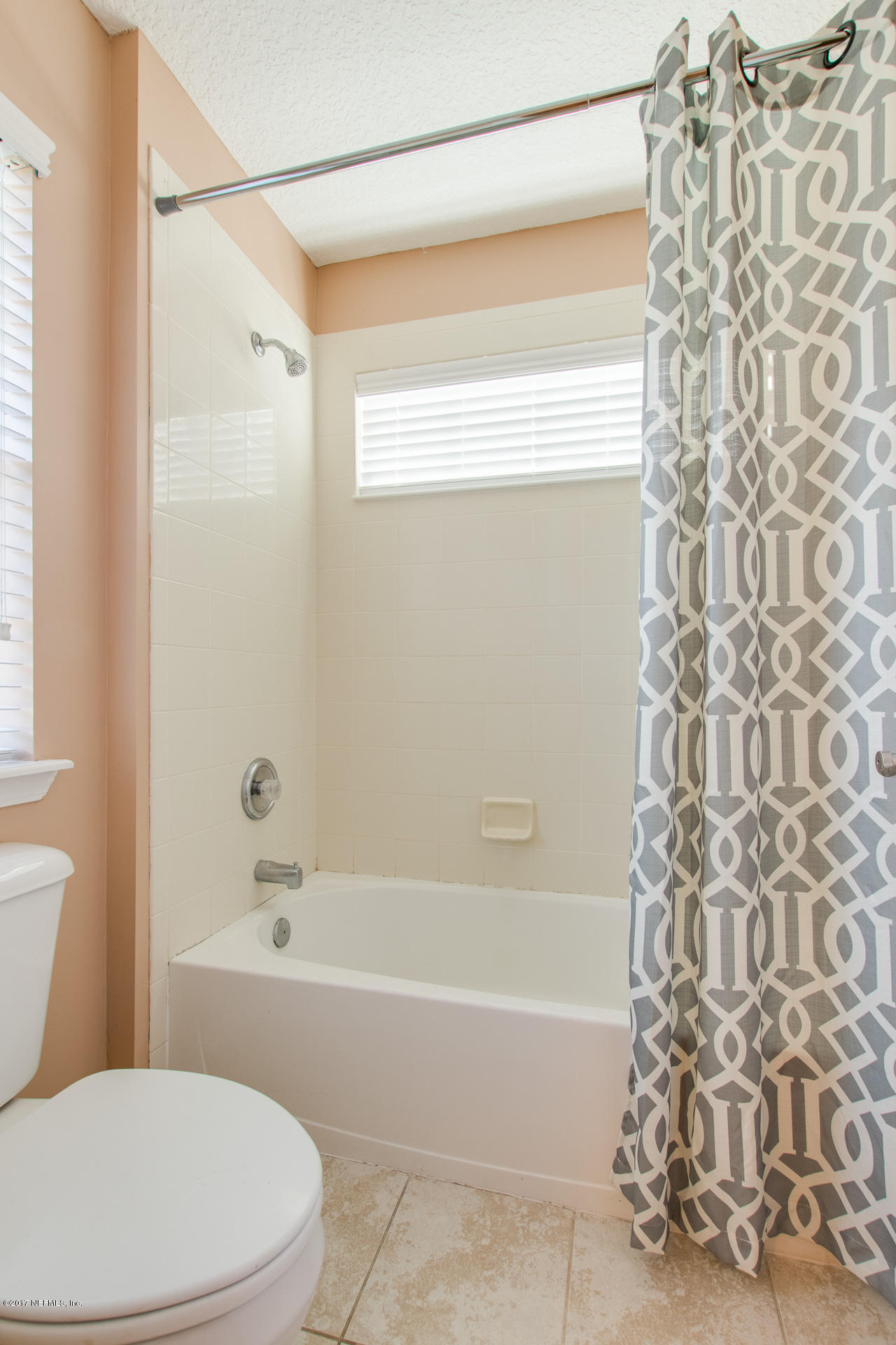 11855 Templeton Road Jacksonville, FL 32258 - Photo 16 of 23 a bathroom with a bathtub and shower