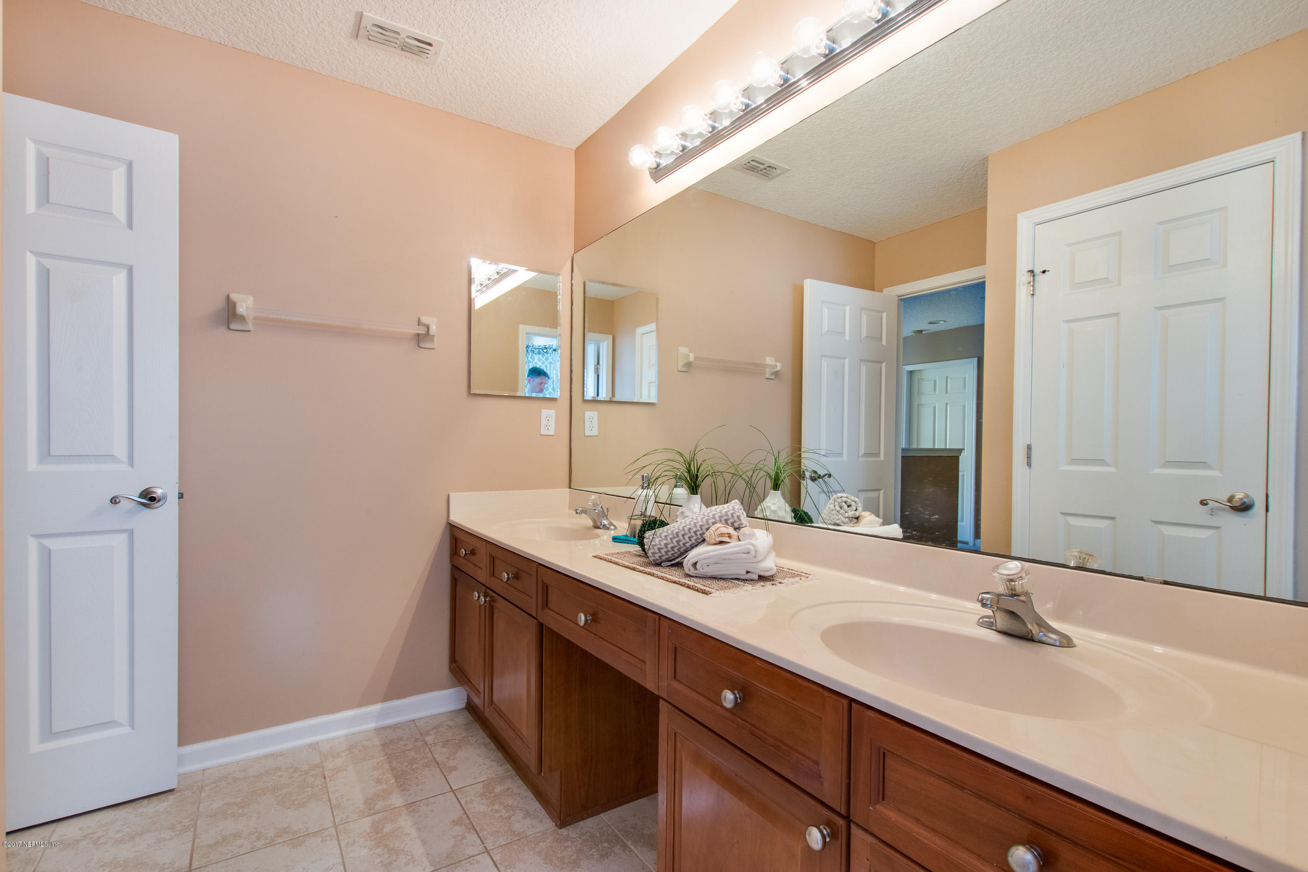 11855 Templeton Road Jacksonville, FL 32258 - Photo 17 of 23 a bathroom with a sink and a mirror