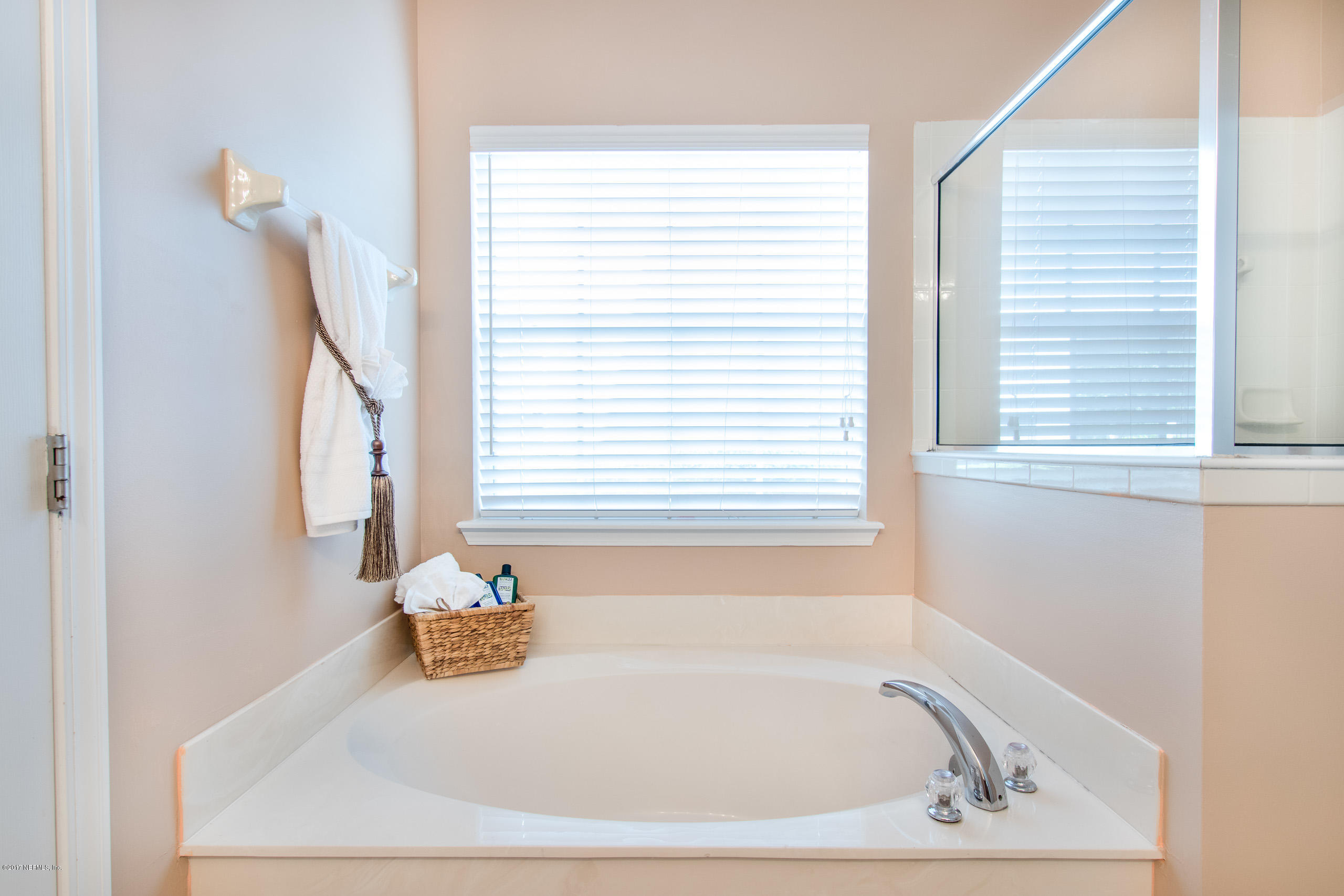 11855 Templeton Road Jacksonville, FL 32258 - Photo 19 of 23 a bath tub sitting in a bathroom next to a window