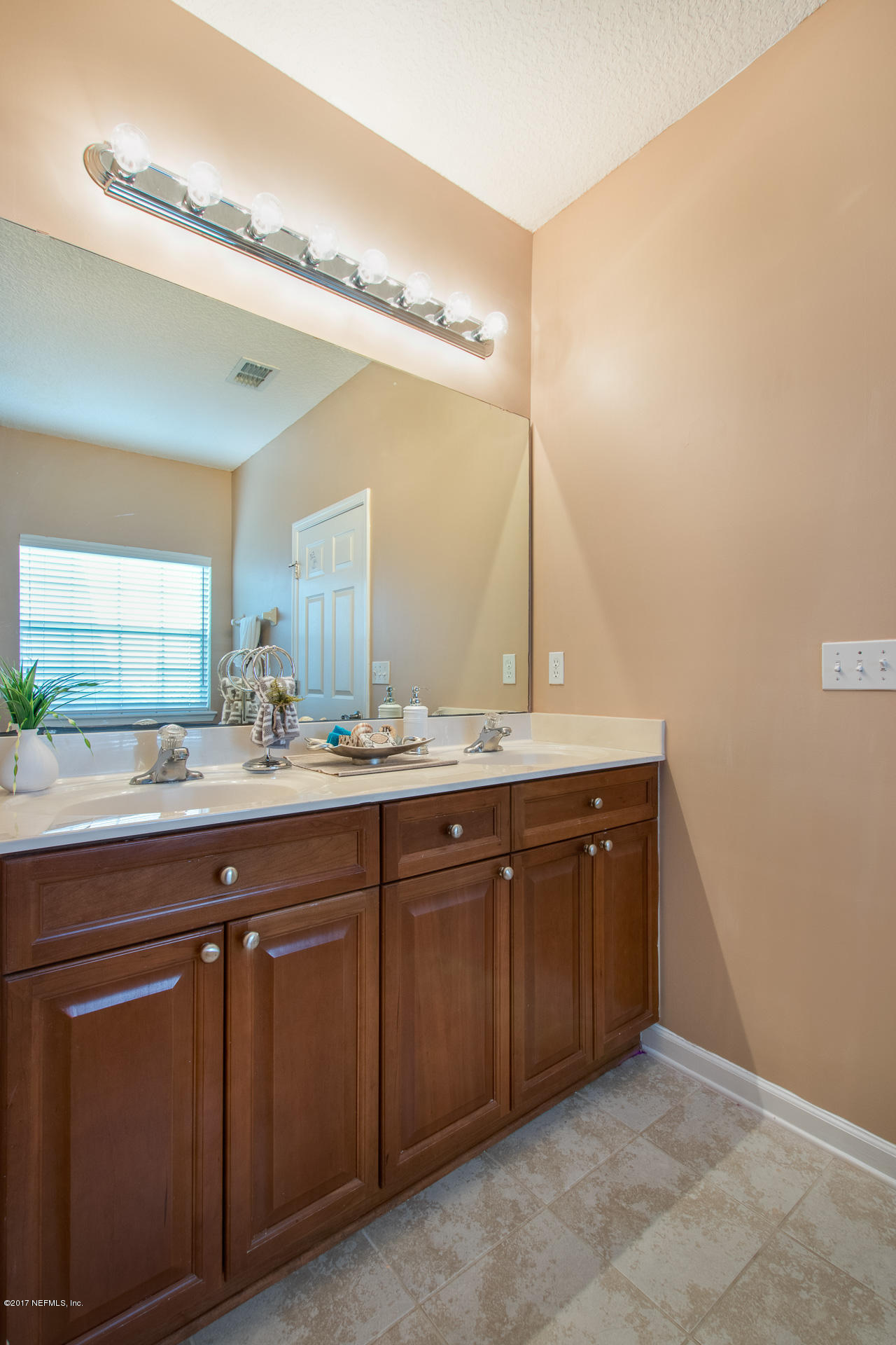 11855 Templeton Road Jacksonville, FL 32258 - Photo 20 of 23 a spacious bathroom with a granite countertop sink and a mirror