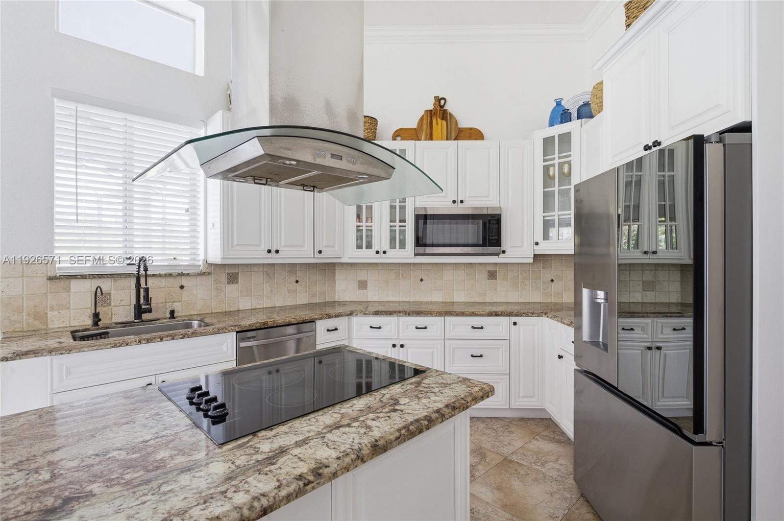 20401 Southwest 48th Place Southwest Ranches, FL 33332 - Photo 17 of 55 a kitchen with stainless steel appliances granite countertop a sink a stove and a refrigerator