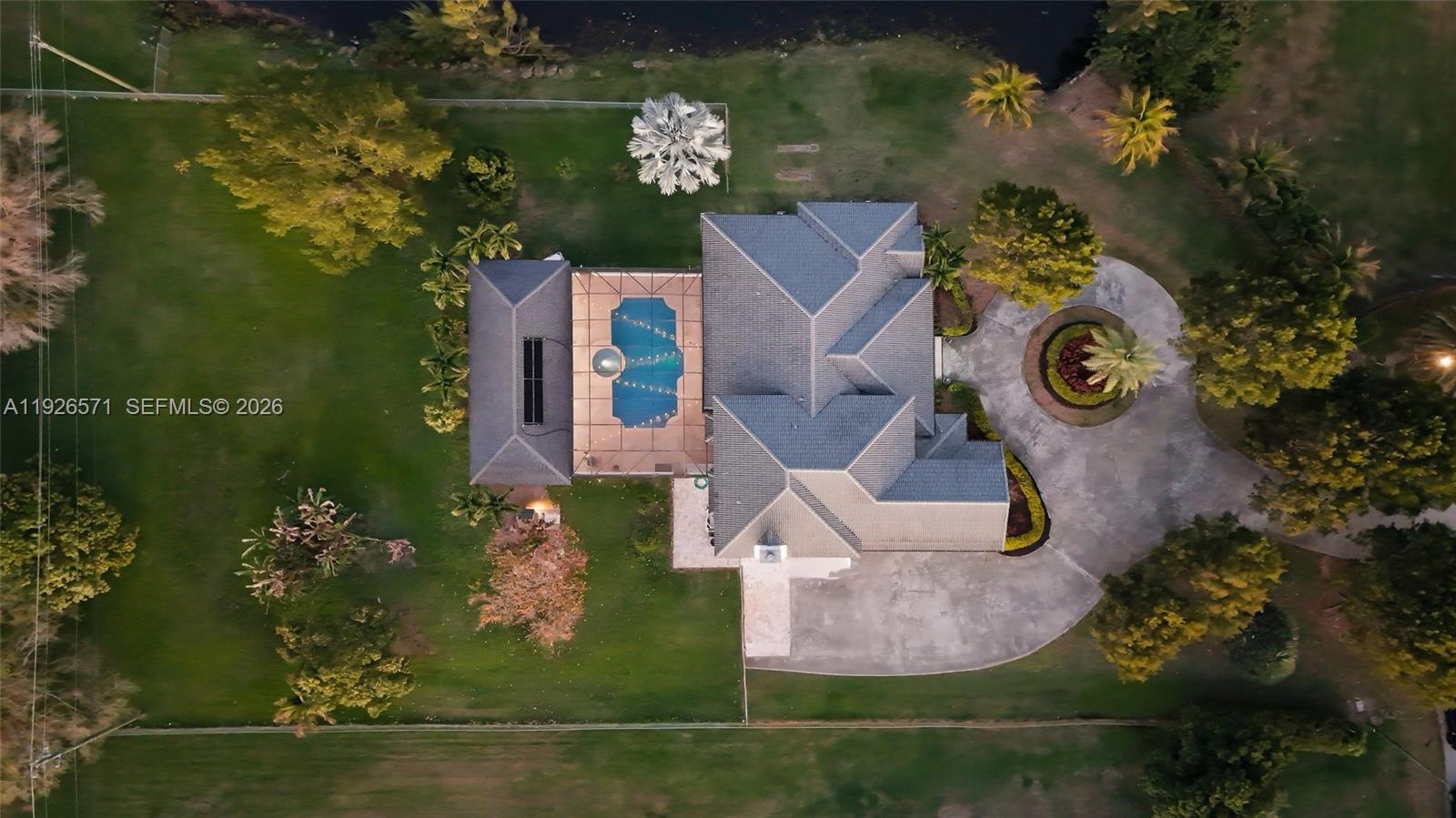 20401 Southwest 48th Place Southwest Ranches, FL 33332 - Photo 48 of 55 an aerial view of a house with outdoor space pool seating area and lake view