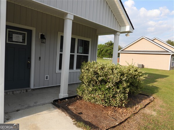 5915 Rye Patch Road Ludowici, GA 31316 - Photo 16 of 25 a front view of a house with garden