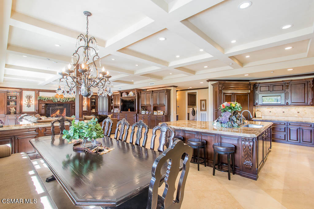 12406 Nelson Road Moorpark, CA 93021 - Photo 18 of 74 a view of a dining room with furniture a chandelier and wooden floor