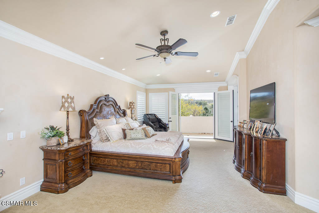 12406 Nelson Road Moorpark, CA 93021 - Photo 28 of 74 a spacious bedroom with a bed and a chandelier