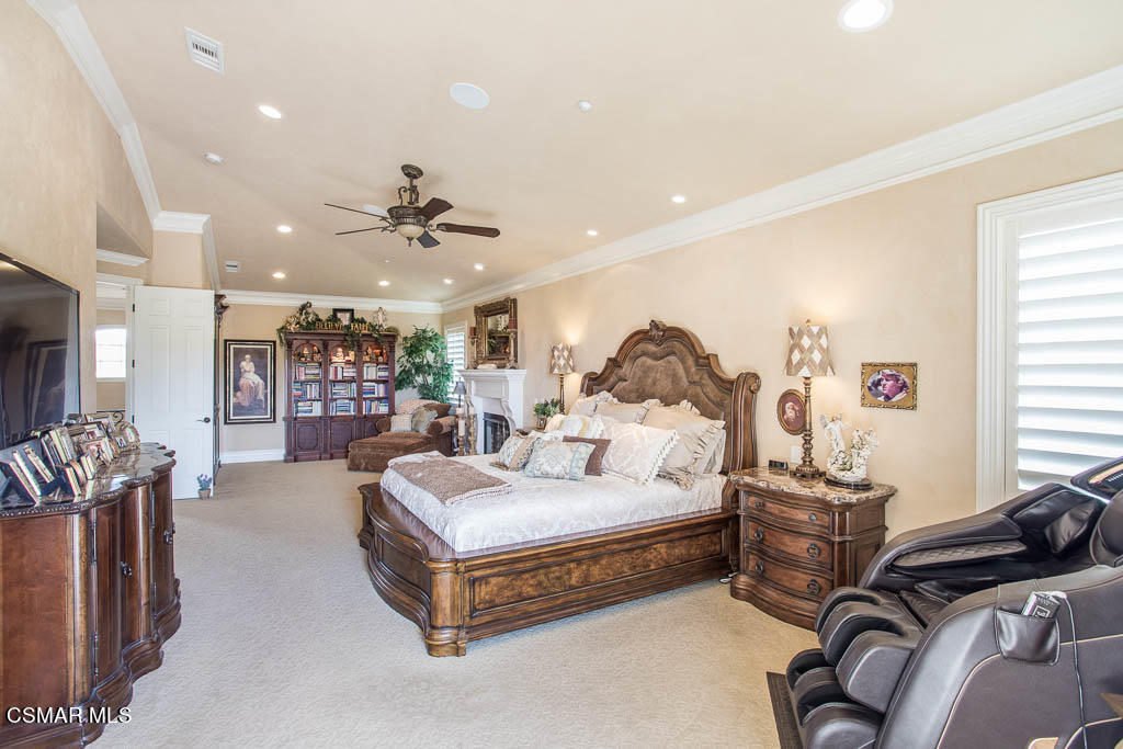 12406 Nelson Road Moorpark, CA 93021 - Photo 29 of 74 a spacious bedroom with a bed a couch and a chandelier