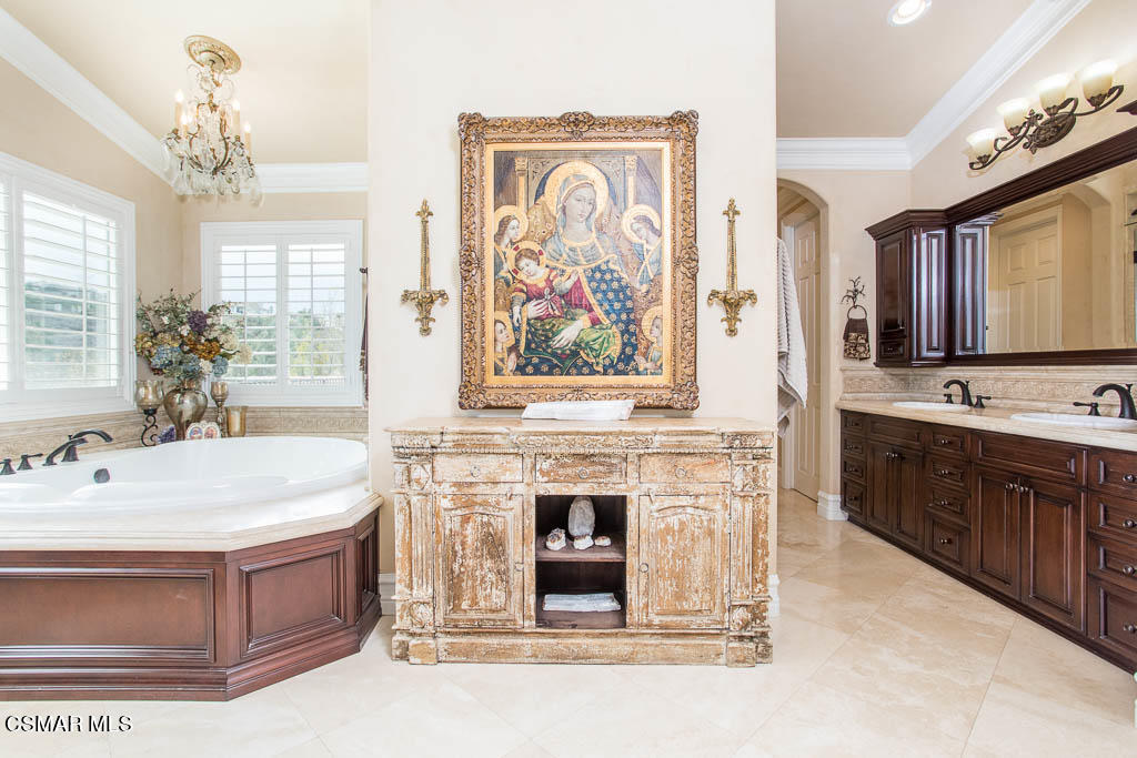 12406 Nelson Road Moorpark, CA 93021 - Photo 32 of 74 a spacious bathroom with a double vanity sink a two mirror a bathtub and a window