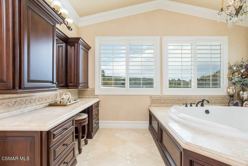 12406 Nelson Road Moorpark, CA 93021 - Photo 34 of 74 a spacious bathroom with a granite countertop sink and a large mirror