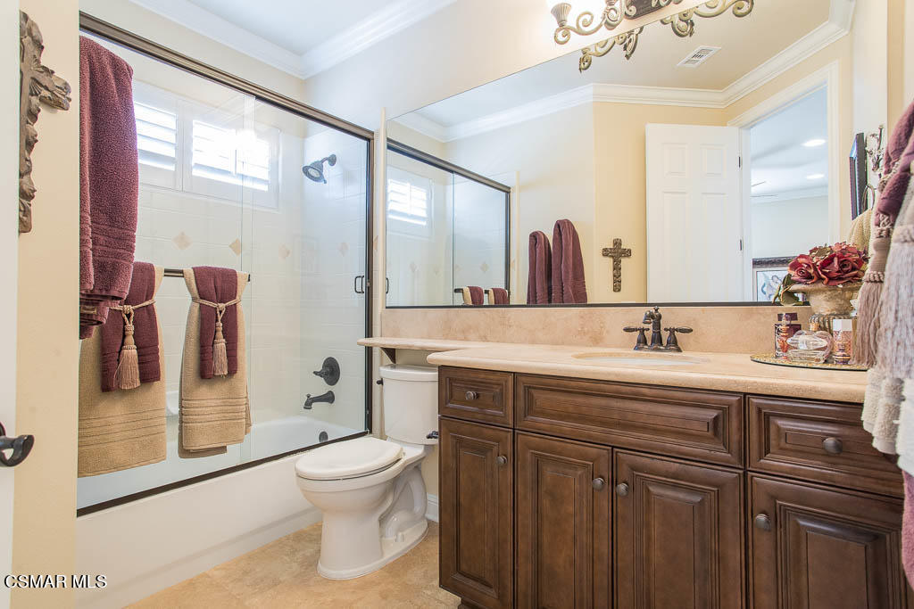 12406 Nelson Road Moorpark, CA 93021 - Photo 36 of 74 a bathroom with a toilet a sink and a large mirror