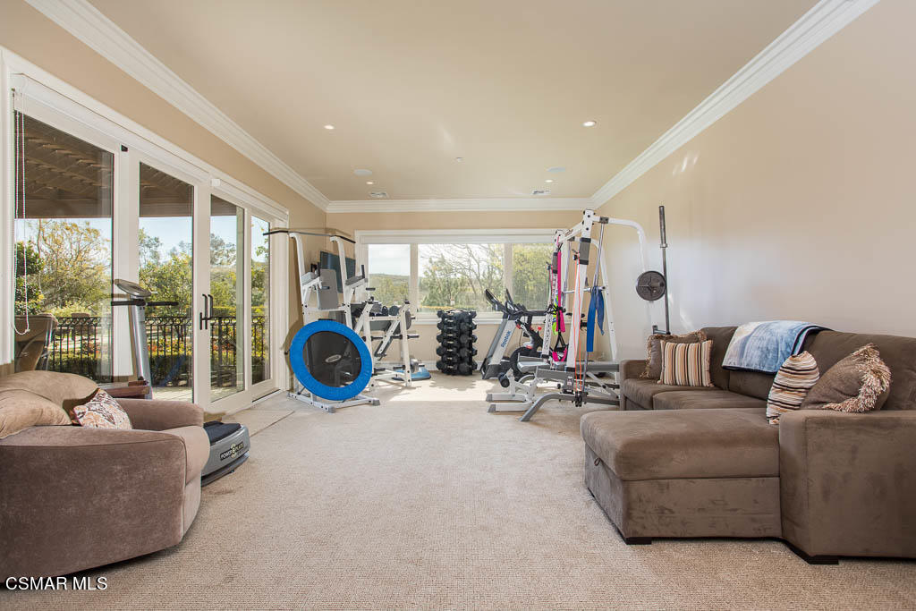 12406 Nelson Road Moorpark, CA 93021 - Photo 45 of 74 a living room with furniture a flat screen tv and a large window
