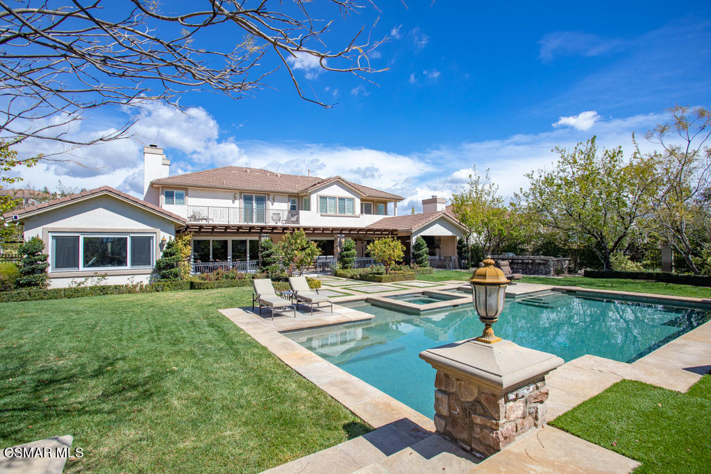 12406 Nelson Road Moorpark, CA 93021 - Photo 53 of 74 a front view of a house with garden and patio