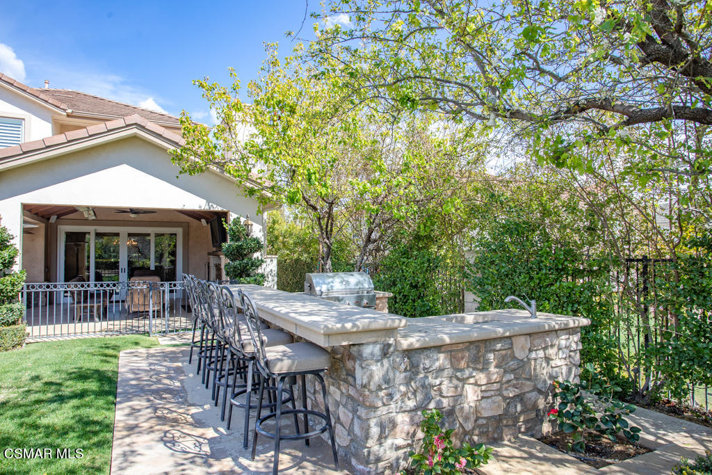 12406 Nelson Road Moorpark, CA 93021 - Photo 60 of 74 a view of a patio with a table and chairs under an umbrella