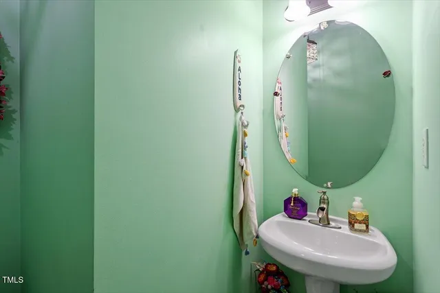 a bathroom with a sink mirror and toilet