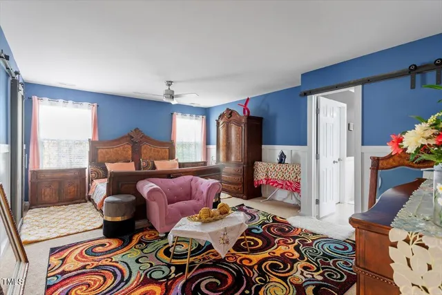 a bedroom with furniture and a chair