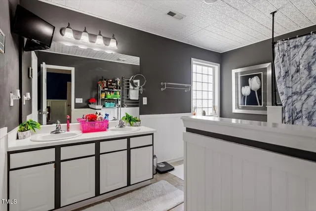 a bathroom with a sink and cabinets