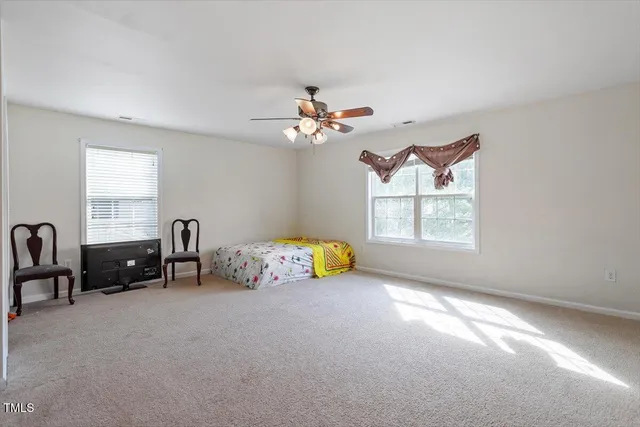 a bedroom with furniture and a window