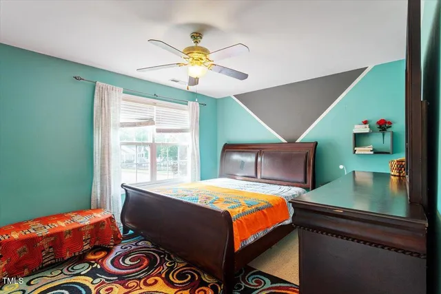 a bedroom with a bed and a chandelier