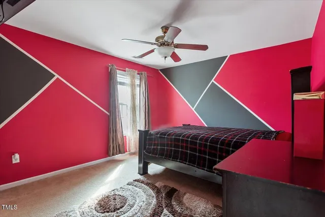 a room with a bed and a ceiling fan