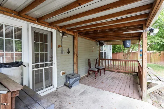 a balcony with a couch and wooden floor