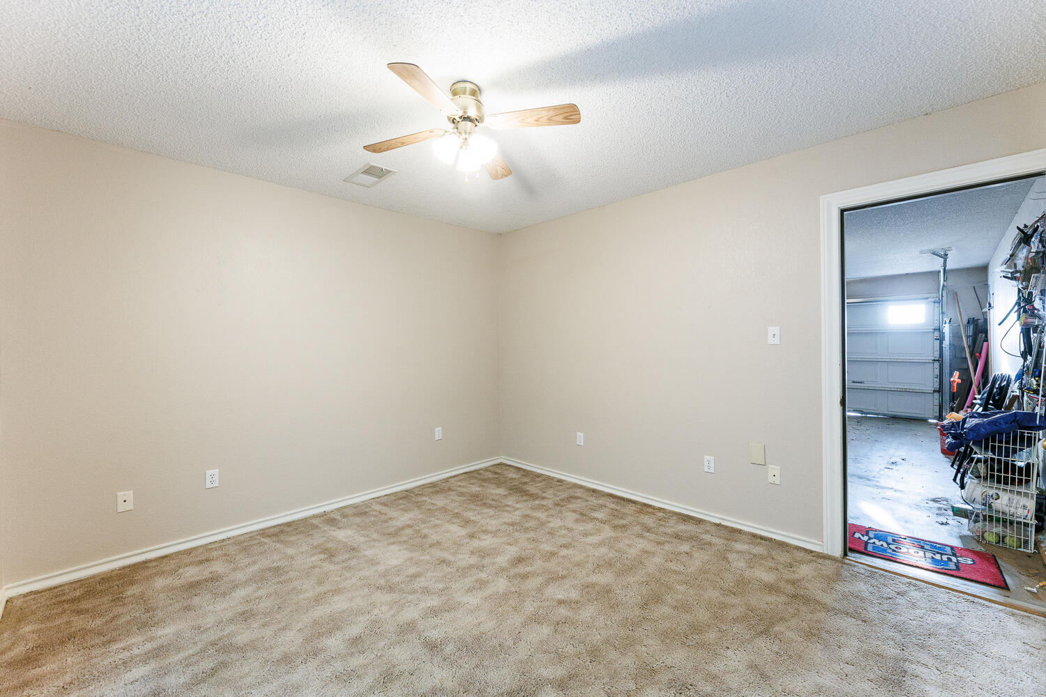 206 Collins Avenue Sundown, TX 79372 - Photo 66 of 82 an empty room with a chandelier fan and kitchen view